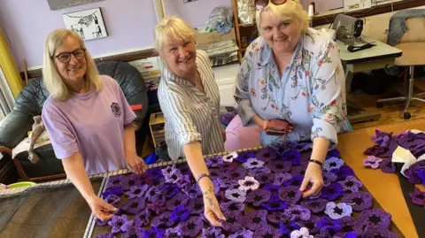 Murphy's Army volunteers showing off their purple poppies 