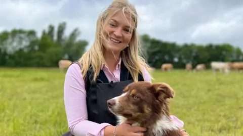 Harriet Cowan with her dog on a farm near Belper