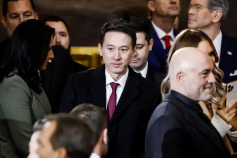 Reuters Shou Zi Chew walking through the inauguration crowd, with podcaster Joe Rogan visible in the foreground