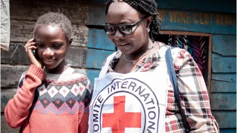 ICRC worker worker with unaccompanied child in DR Congo