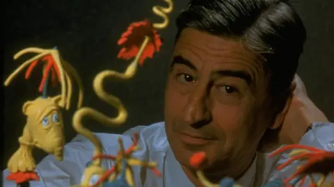 Getty Images 1959: Children's book author/illustrator Theodor Seuss Geisel posing with models of characters he has created. 