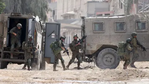 Getty Images Israeli soldiers raid Nur Shams refugee camp, near Tulkarm, in the occupied West Bank (28 August 2024)