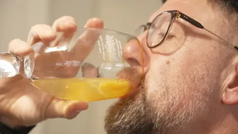 BBC A man drinking a glass of egg yolks