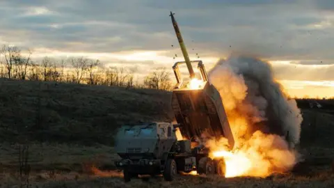 An M142 HIMARS launches a rocket on Russian position in Ukraine during a mission in December 2023