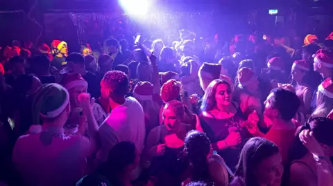 Clubbers dancing in Santa hats in The Shed 