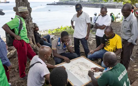 Patrick Meinhardt/AFP People play dominos in Moroni, the Comoros - Saturday 6 May 2023
