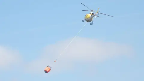 Helicopter deploying water