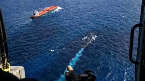 Twitter/@DeptofWar The tanker and a US ship, viewed from a helicopter gunship