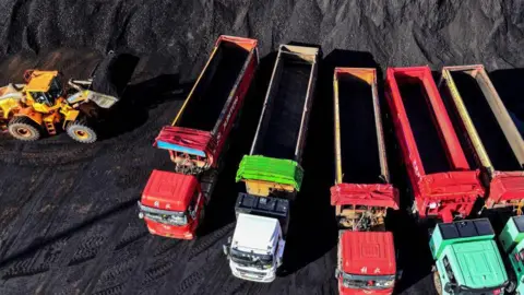 Getty Images vehicles will move coal to the coal terminal at Lianyongang port in Lianyongang, Jiangsu Province, eastern China