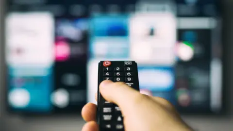 Person holding remote control