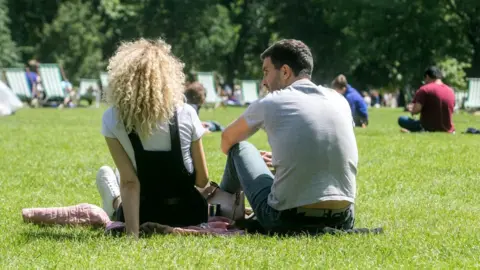 Getty Images Two people relaxing in a park