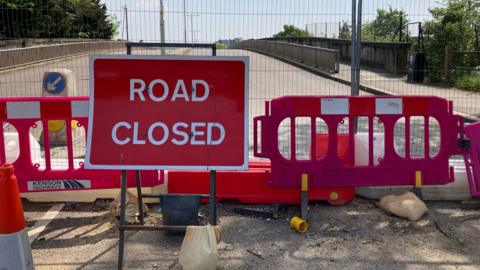Road closure signs at the closed Broadmead Road Bridge in north-east London