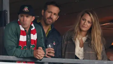 Getty Images Mac, Reynolds and Lively in the stands of the Racecourse