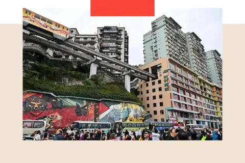 Hector Retamal/ AFP via Getty Images Tourists take pictures of a train arriving in Chongqing in southwestern China