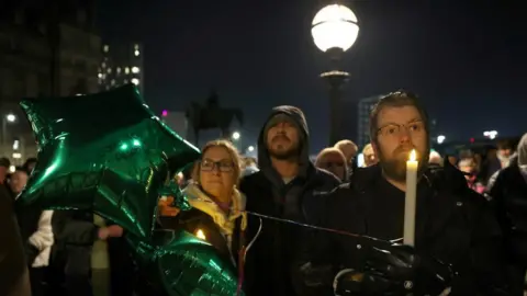 Reuters Image shows people attending a vigil for James Lee Williams, popularly known as The Vivienne, in Liverpool, Britain, on 12 January, 2025
