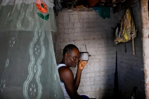 Nacho Doce / Reuters Fisherman Jose da Cruz listening to his radio