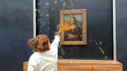Mona Lisa: Man dressed as old woman throws cake at da Vinci painting
