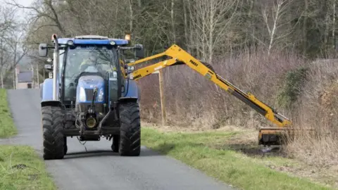 Getty Images A tractor-mounted hedge cutter in action