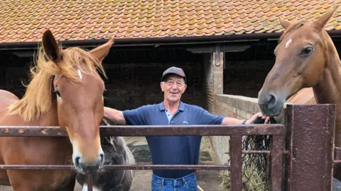 Darren Rozier/BBC Livestock manager Steve Swan pictured with two of Easton Farm Park's Suffolk Punch horses