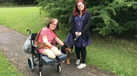 Hannah Coster Caroline Coster in a wheelchair