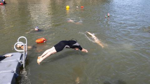 People seen swimming in the river Seine
