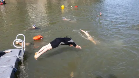 People seen swimming in the river Seine
