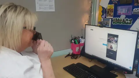 Edward Peake Middle School Tina Clarke at a computer talking to Vernon Kay on the Radio 2 breakfast show