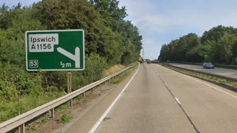 Google Maps A street view image of the A14 from the perspective of a driver. On the left hand side of the image is a road sign with Ipswich written on it.