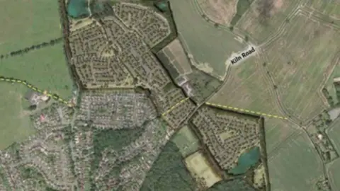 A proposed development site showing proposed homes on a number of fields.