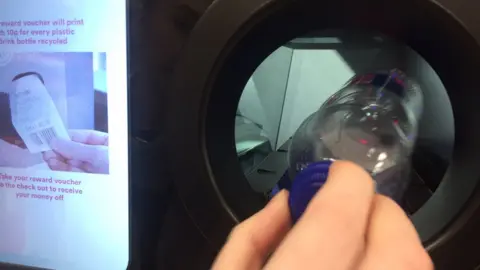 The machine scans a barcode and decides to accept or reject the bottle