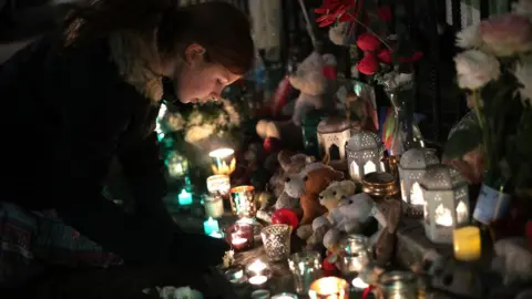 PA Girl lights candle