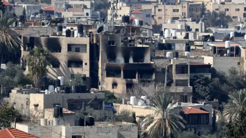 EPA Scorch marks on a Palestinian homes during the ninth day of an Israeli military operation in Jenin, in the occupied West Bank (29 January 2025)