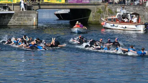 MANX SCENES Teams competing in the snake race, which the interlinked inner tubes of tyres.