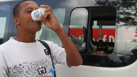 Jed Lesperance taking his methadone at a mobile clinic in Seychelles