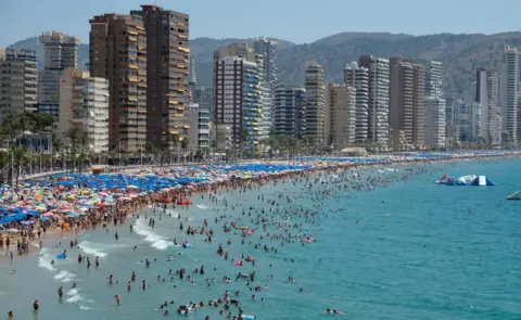 Reuters People cool off at the beach during the heatwave in the southeastern coastal town of Benidorm