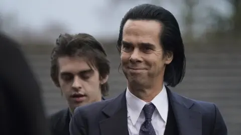 PA Media Singer Nick Cave performed during the ceremony