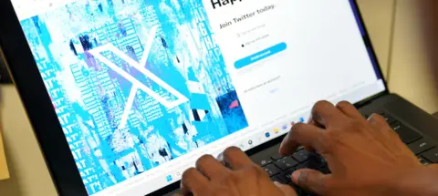 PA Media File photo dated 24/07/23 of a person signs into the Twitter website which is now displaying the new logo for Twitter and its new name X