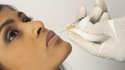 Woman being injected with filler