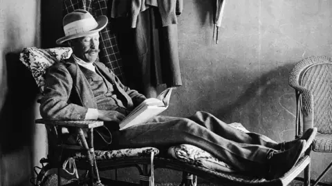 Getty Images British Egyptology patron George Herbert, Fifth Earl of Carnarvon (1866 - 1923) reclines on a wooden easy chair and reads a book, Egypt, 1923. 