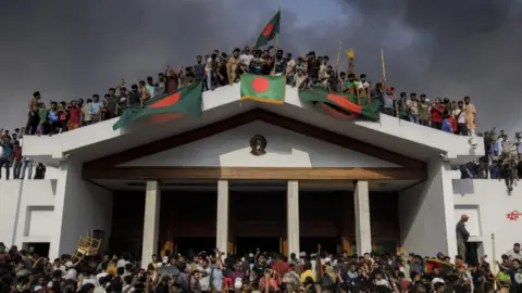 EPA People gather around the residence of the Bangladeshi prime minister in Dhaka on 5 August