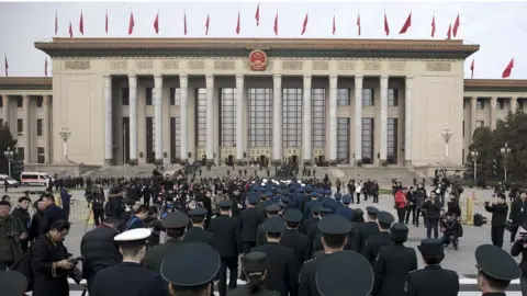 Getty Images Delegates and security at the Great Hall of the People in Beijing (5 march 2018)