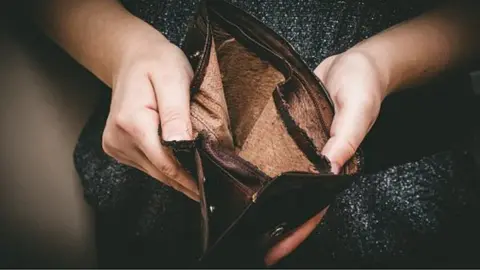 Getty Images Woman with empty purse