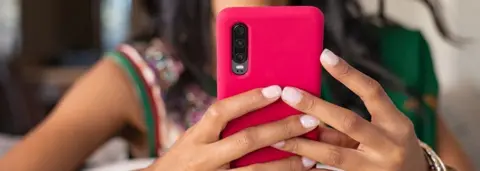 Getty Images Representational image: A woman holding a mobile phone.