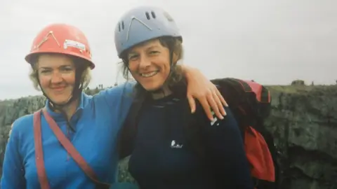 Penny Kirby Two women in hard hats and mountain climbing gear