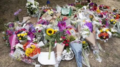 EPA Flowers left in tribute to Aiia Maasarwe