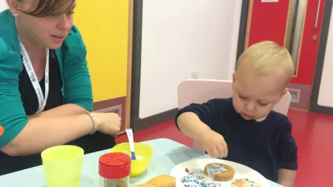 BBC Child decorating empire biscuits