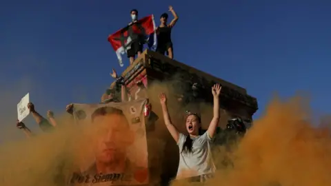 Reuters People participate in a demonstration after Lucia Hiriart, the widow of Former Chilean dictator Augusto Pinochet, passed away, in Santiago