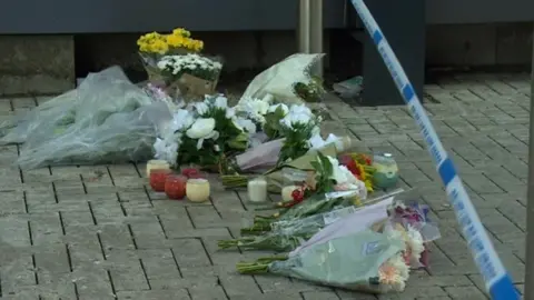Flowers left at the scene of the stabbing