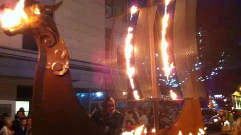 BBC Torchlight procession featuring a Viking longboat in the 2012 Preston Guild.