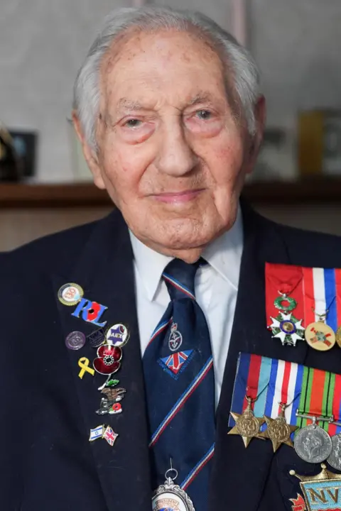 PA Media D-Day veteran and Ambassador for the British Normandy Memorial Mervyn Kersh is pictured wearing a suit and tie with numerous war medals and pin badges